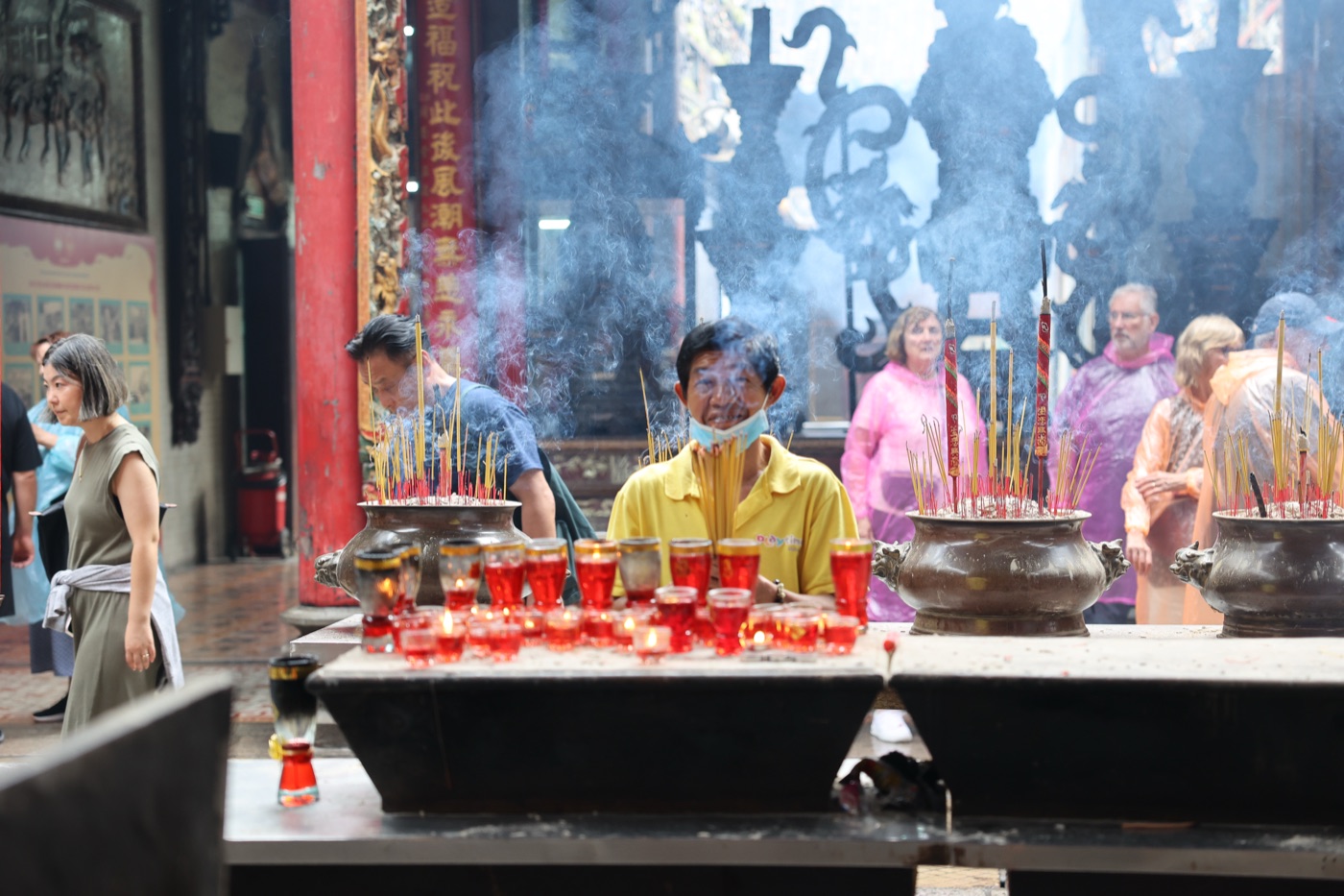 Worshippers lighting incense and red candles at a temple in Ho Chi Minh City