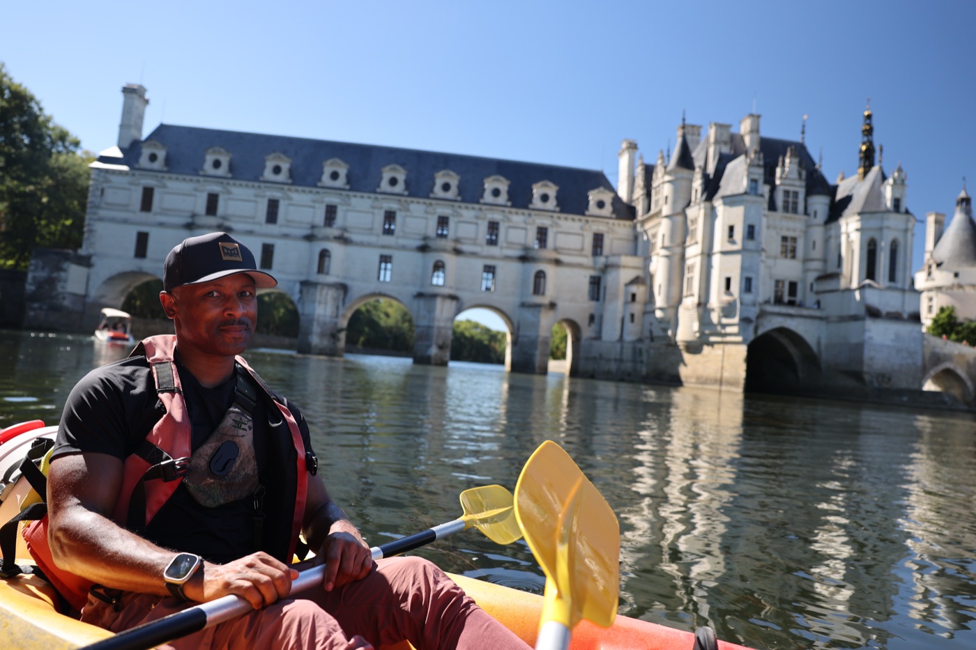 Casey Drummond in a kayak on the river in front of Château de Chenonceau